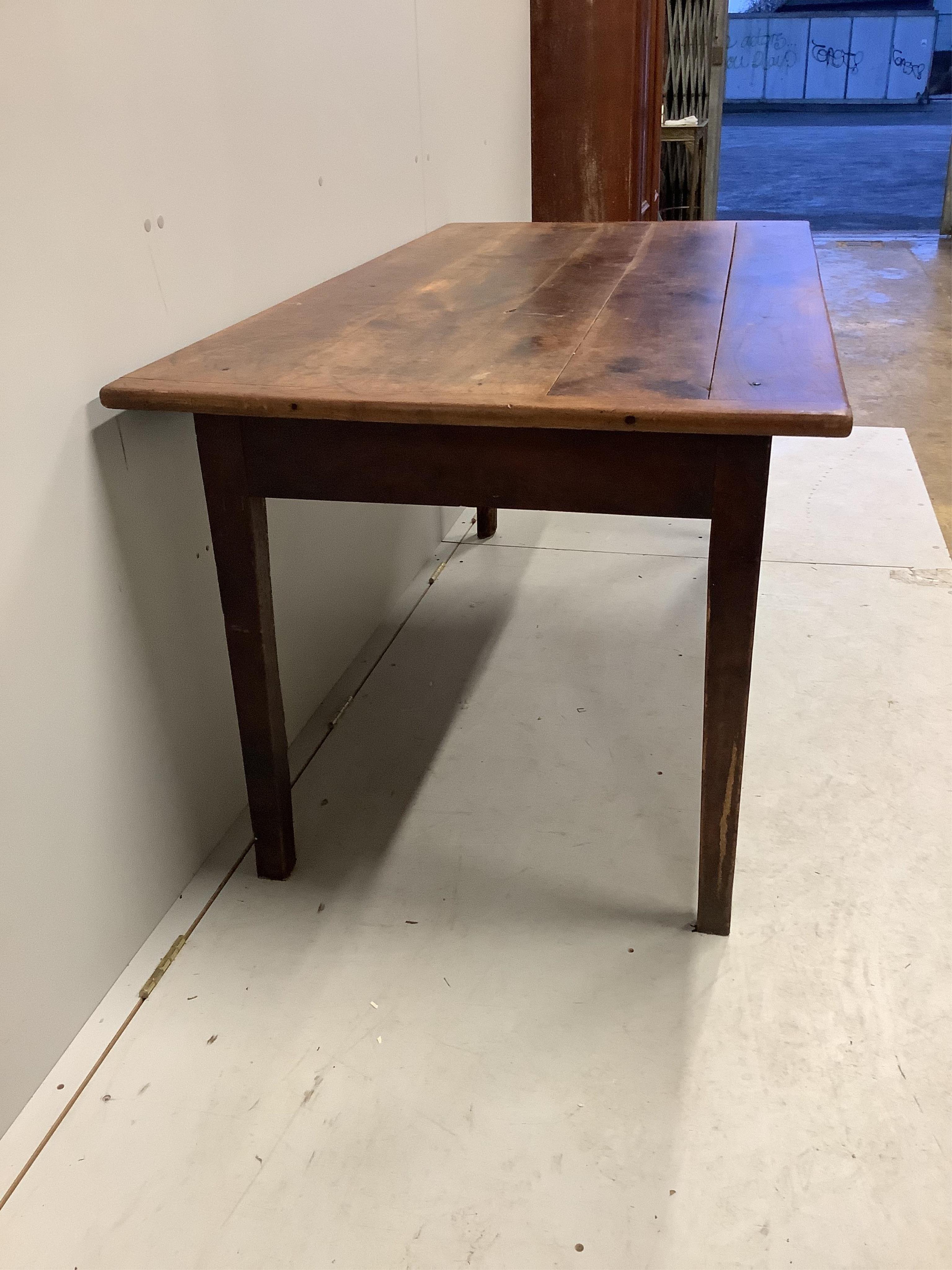 A 19th century French rectangular oak kitchen table, fitted drawer on square tapered legs, width 164cm, depth 83cm, height 72cm. Condition - fair, top with knot hole, all legs have losses due to old worm infestation, now